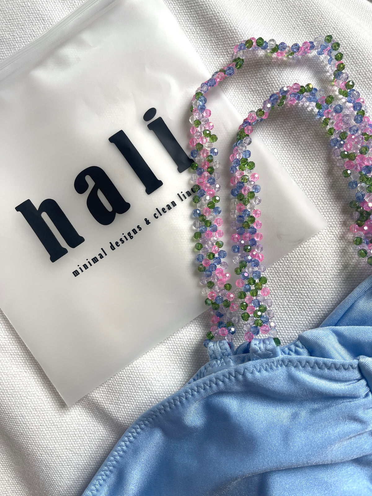 Light blue bikini top with back tie and multicolor beaded shoulder straps – elegant and playful swimwear- European summer 